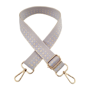 Detail of lavender and beige diamond-pattern woven strap with light gold metal hardware