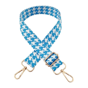 Macro detail of blue houndstooth strap with golden metal swivel hooks for handbags