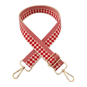 Close-up of red and white checkered adjustable bag strap with gold metal swivel hooks