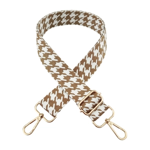 Detail of adjustable houndstooth shoulder strap with premium gold metal hardware