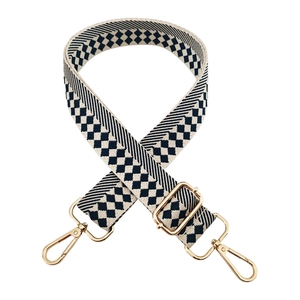 Detail of adjustable woven wide shoulder strap with blue checkered jacquard and gold hooks