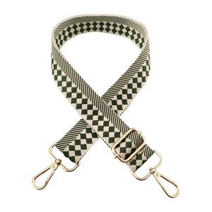 Detail of adjustable checkered jacquard bag strap with gold metal swivel hooks and buckles