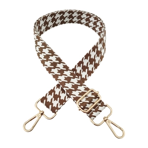 Detail of 3.8cm houndstooth jacquard strap with gold lobster clasps and metal hardware