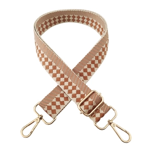 Detail of checkered jacquard weave shoulder strap with gold metal swivel hooks