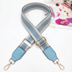 Detail of adjustable blue chevron woven strap with golden lobster clasps and leather ends