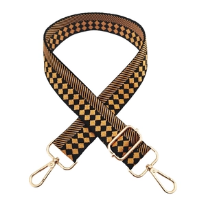 Detail of checkered woven shoulder strap with gold alloy hooks and adjustable buckle