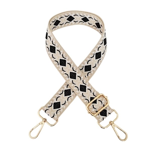 Close-up of ethnic geometric weave shoulder strap with gold metal buckles