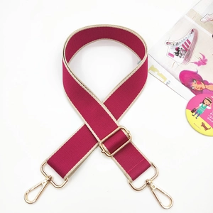Detail showing the adjustable rose pink wide bag strap with gold metal swivel lobster hooks