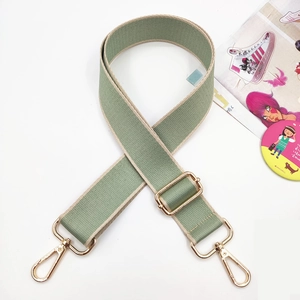 Detail of adjustable wide shoulder strap in bean green with gold lobster clasps