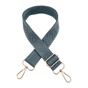 Detail of adjustable blue geometric diamond jacquard strap with gold metal hooks