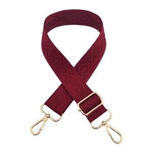 Detail of burgundy adjustable wide shoulder strap with geometric diamond weave pattern