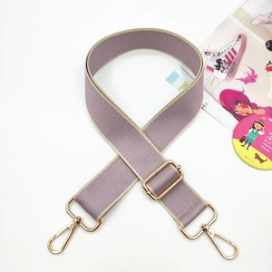 Detail of adjustable wide canvas shoulder strap in lavender with gold metal swivel hooks
