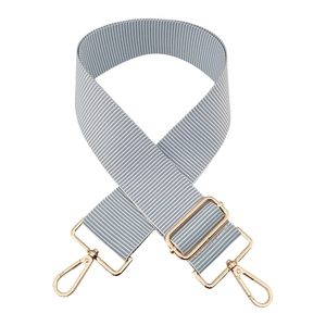 Detail of 5cm wide blue and white striped adjustable bag strap with gold metal lobster clasps