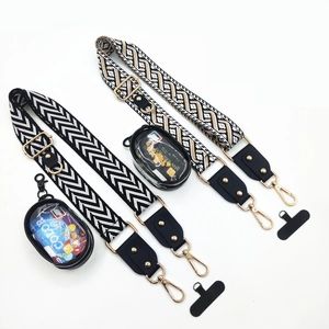 Detail of adjustable woven crossbody straps with gold buckles and clear coin pouches