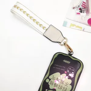 Crossbody phone strap with gold sequins and a cat print card holder pouch on white background