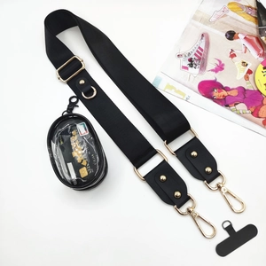 Detail of adjustable black nylon phone strap with golden hooks and a round mini pouch