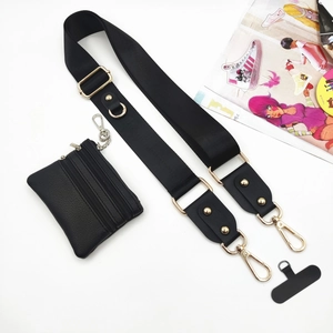 Detail of adjustable black nylon shoulder strap with mini zip pouch and gold hardware