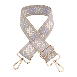 Detail of floral embroidery on adjustable beige bag strap with gold swivel hooks