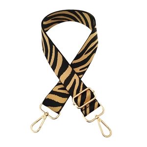 Adjustable wide zebra print bag strap with gold metal lobster clasps on white background