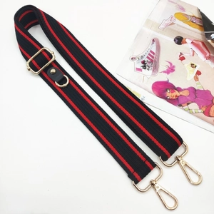 Close-up of red and black striped replacement strap with gold metal lobster clasps
