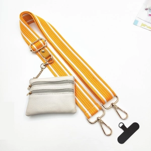 Detail of adjustable orange and white striped bag strap with a white leather coin purse