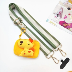 Detail of green striped adjustable wide strap with cute yellow plush animal pouch charm