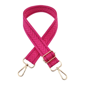 Close-up of rose red woven wide bag strap with golden metal lobster clasps and V-pattern