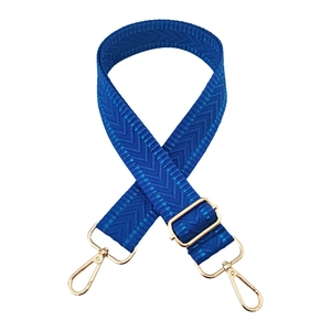 Close-up of blue chevron weave bag strap with adjustable gold-tone metal hardware