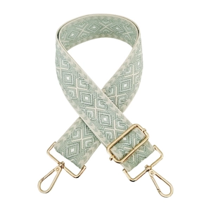 Detail of mint green and white diamond pattern woven strap with gold lobster clasps
