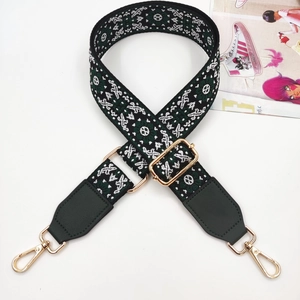 Detail of adjustable geometric jacquard strap with gold lobster clasps and leather ends