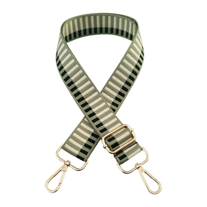 Detail of adjustable green and beige striped woven bag strap with gold metal lobster clasps