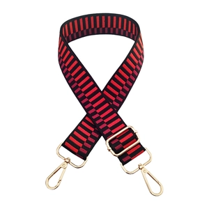 Adjustable bag strap with red and black geometric stripes and golden hardware