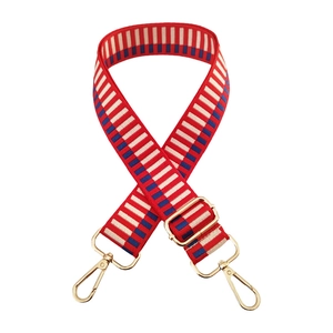 Close-up of red, white, and blue striped woven shoulder strap with gold metal hooks