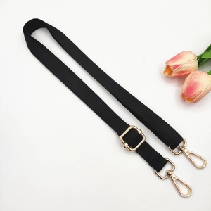 Detail of 2cm wide black cotton strap with adjustable gold lobster buckles for crossbody bags