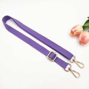 Detail of adjustable purple cotton webbing strap with premium gold swivel snap hooks