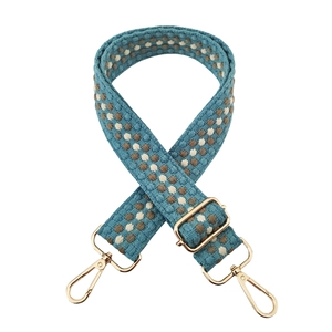 Adjustable wide woven shoulder strap with blue jacquard pattern and gold metal hooks