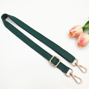 Detail of adjustable dark green bag strap with elegant gold swivel lobster clasps