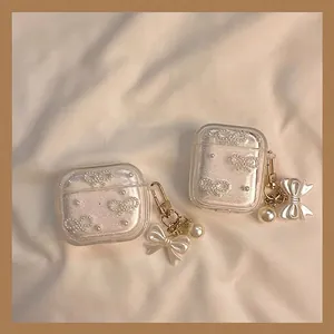 Funda brillante para AirPods con lazo de perlas y elegante colgante dorado