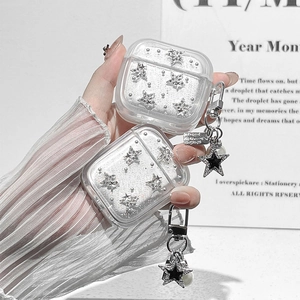 Sparkly AirPods case with silver stars and pearl charms held by a model