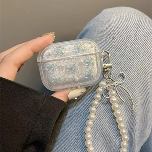 Clear AirPods Pro case with silver glitter, butterfly accents, and a pearl strap