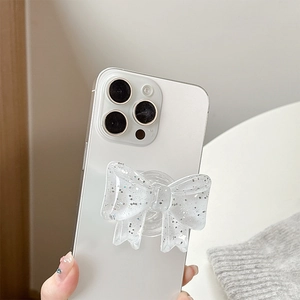 Close-up of a 3D transparent glitter bow phone grip stand with silver sparkles