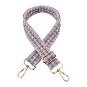 Detailed close-up of lavender woven shoulder strap with gold-tone hardware and buckles