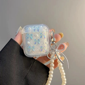 Close-up of glitter AirPods case with iridescent bow and elegant pearl chain strap