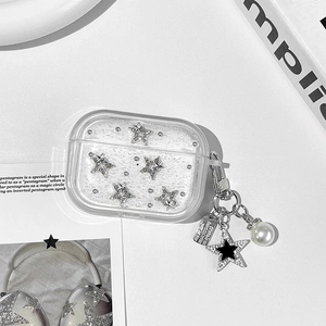 Detail of clear AirPods Pro case with silver glitter, diamond stars and pearl pendant