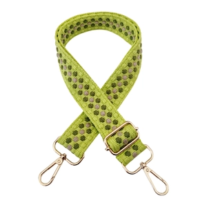 Detail of adjustable woven bag strap in cyan with green patterns and gold metal buckles