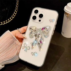 Close-up of luxury transparent iPhone case with sparkling rhinestone bow tie embellishment