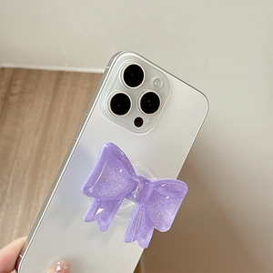 Supporto per telefono a fiocco viola glitterato con brillantini su smartphone bianco