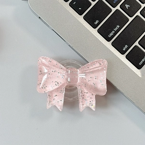 Close-up of pink glitter bow phone socket with translucent resin and silver sparkles