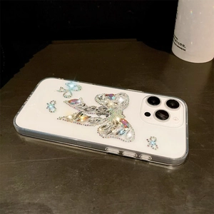 Detailed close-up of handmade 3D crystal butterfly rhinestone on transparent iPhone case