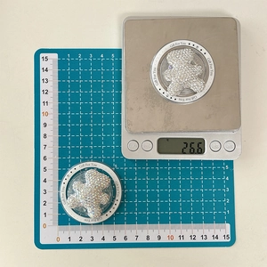 Detailed view of rhinestone bear phone grip on scale showing weight of 26.6 grams